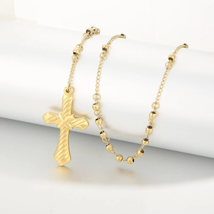Detailed view of a 6mm golden stainless steel rosary necklace with a cross pendant