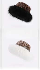 Detail of plush leopard print faux fur winter hats with soft fuzzy trim in black and white