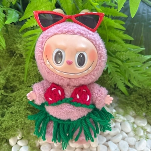 Macro detail of pink plush toy wearing red cat-eye sunglasses and summer knit outfit
