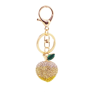 Sparkling crystal apple keychain in gold metal with gradient rhinestones and green leaf charm