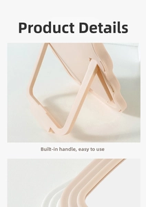 Detail of pink wavy vanity mirror featuring adjustable stand and portable handle design