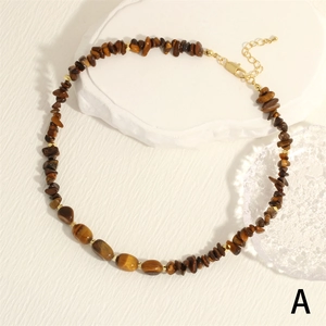 Detail view of tiger eye stone necklace with gold lobster clasp and extension chain