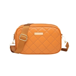 Orange quilted faux leather crossbody bag with gold hardware and adjustable strap