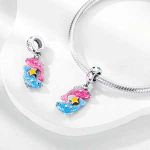 Detail of S925 sterling silver Pisces charm with pink and blue enamel fish and star