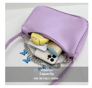 Interior view of purple baguette bag showing capacity for phone and cosmetics