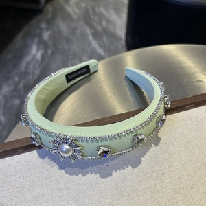 Detail of mint green padded headband with crystals, pearls and handmade label