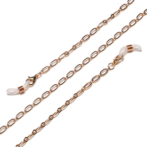 Detailed macro of golden metal eyeglass chain with lobster clasps and silicone loops