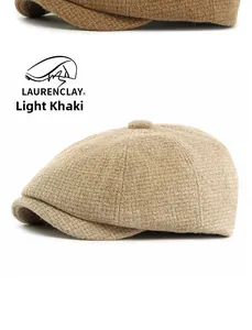 Detail view of light khaki wool blend newsboy cap showing tweed texture and button top