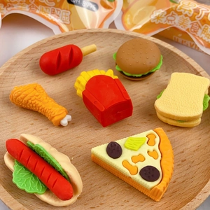 Close-up of cute cartoon fast food erasers like hamburger and pizza on a wooden tray