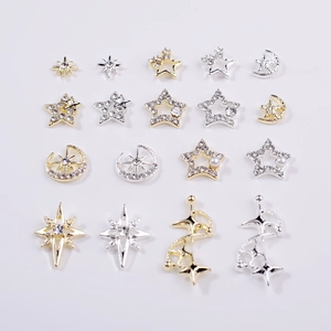 Detailed view of alloy star and moon nail art charms with pearls and rhinestones