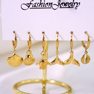 Golden stainless steel ocean themed earring set featuring shells and sea turtle charms