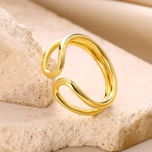 Close-up of a double-layered wavy gold-plated ring with a high-polished finish on stone