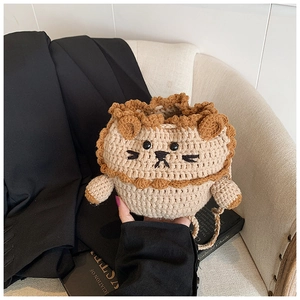 Detailed view of a handmade crochet lion bag with beige yarn and a brown mane
