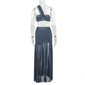 Detail of navy blue two-piece set featuring one-shoulder top and mesh patchwork skirt