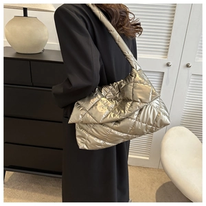Quilted metallic silver shoulder bag detail with glossy finish on a puffer style design