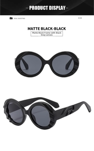 Detail of matte black oversized round sunglasses with unique 3D wavy textured frames