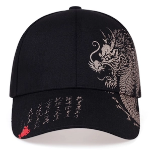 Detail view of golden dragon embroidery and Chinese calligraphy on black baseball cap