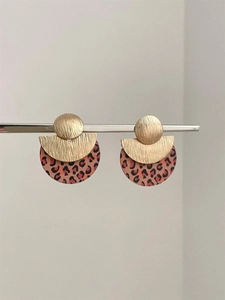 Detail of geometric round leopard print earrings with gold metal and wood textured finish