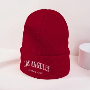 Détail du bonnet rouge foncé avec broderie Los Angeles blanche et texture tricotée élégante