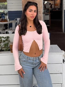 Pink slim fit long sleeve knitted cardigan with front buttons in a street style setting
