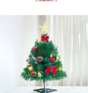 Close-up of 50cm tabletop mini Christmas tree with red bows, gold bells and ornaments
