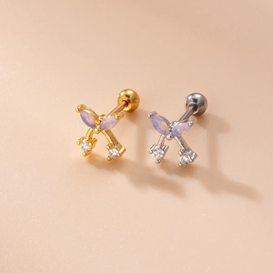 Detail of gold and silver bow stud earrings with opal stones and zircon screw backs