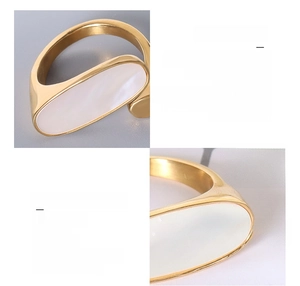 Macro shot of 18k gold plated titanium ring with oval white shell and brushed metal finish