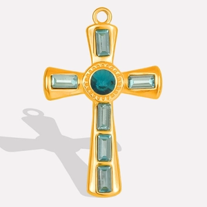 Close-up of gold stainless steel cross pendant with blue crystal gemstone inlays