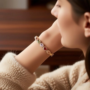 Detail of vintage gold bracelet featuring oval multi-color gemstones and sparkling zircon pavé
