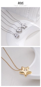 Detailed shot of gold and silver heart, star, and water drop pendants with gemstones
