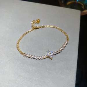 Detail of gold bead bracelet featuring marquise-cut zircon flower and adjustable chain