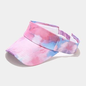 Detailed view of pink and blue tie-dye sun visor hat with wide brim and adjustable strap