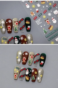 Detailed macro view of 5D embossed Christmas nail stickers with 3D texture and festive icons