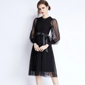 Elegant knit midi dress with sheer polka dot puff sleeves and bow tie waist detail