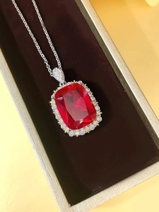 Macro view of luxury rectangle ruby pendant with yellow and white diamonds in a box
