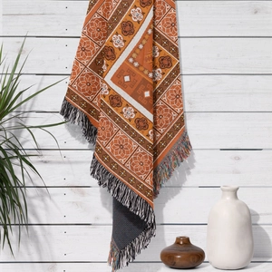 Close-up of Bohemian knit blanket with vintage geometric patterns and colorful tassels