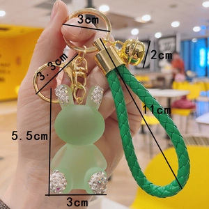 Detailed dimensions of the green jelly rabbit keychain with woven strap and rhinestones
