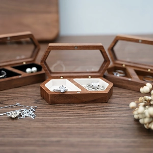 Detail view of hexagonal walnut wood jewelry box with velvet lining for rings and necklaces