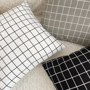 Close-up of textured linen checkered pillowcases in black, white, and grey tones