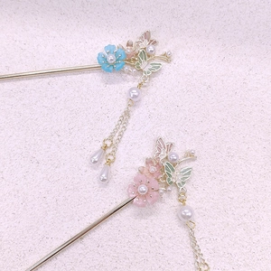 Detailed view of Chinese hairpins with blue and pink flowers and pearl tassels