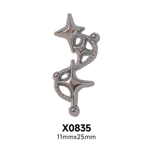 Macro shot of silver punk-style double star nail charms with metal spiral texture