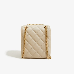 Detail of beige quilted PU leather crossbody bag with elegant gold metal chain strap
