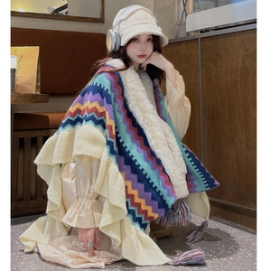 Knitted vintage poncho with colorful wave pattern, faux fur collar, and tassel fringe