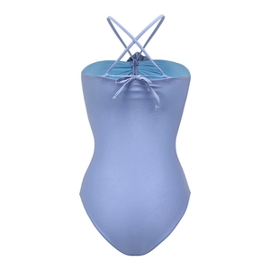 Detail of lavender one-piece swimsuit featuring a bright blue lining and lace-up back