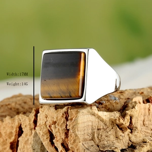 Men's square tiger eye stone ring in polished stainless steel on natural bark base
