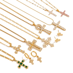 Gold cross jewelry set with zircon pendants on various chains against a white background
