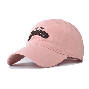 Detail of pink cotton baseball cap featuring high-quality 3D letter embroidery and curved brim