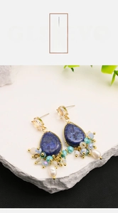 Detail of vintage long drop earrings with Lapis-like stone and baroque pearls