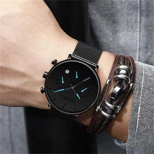 Detail of Geneva black mesh strap watch and brown leather bracelet on male wrist