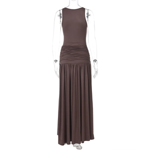 Détail d'une robe mi-longue marron sans manches avec plis à la taille et ourlet à volants